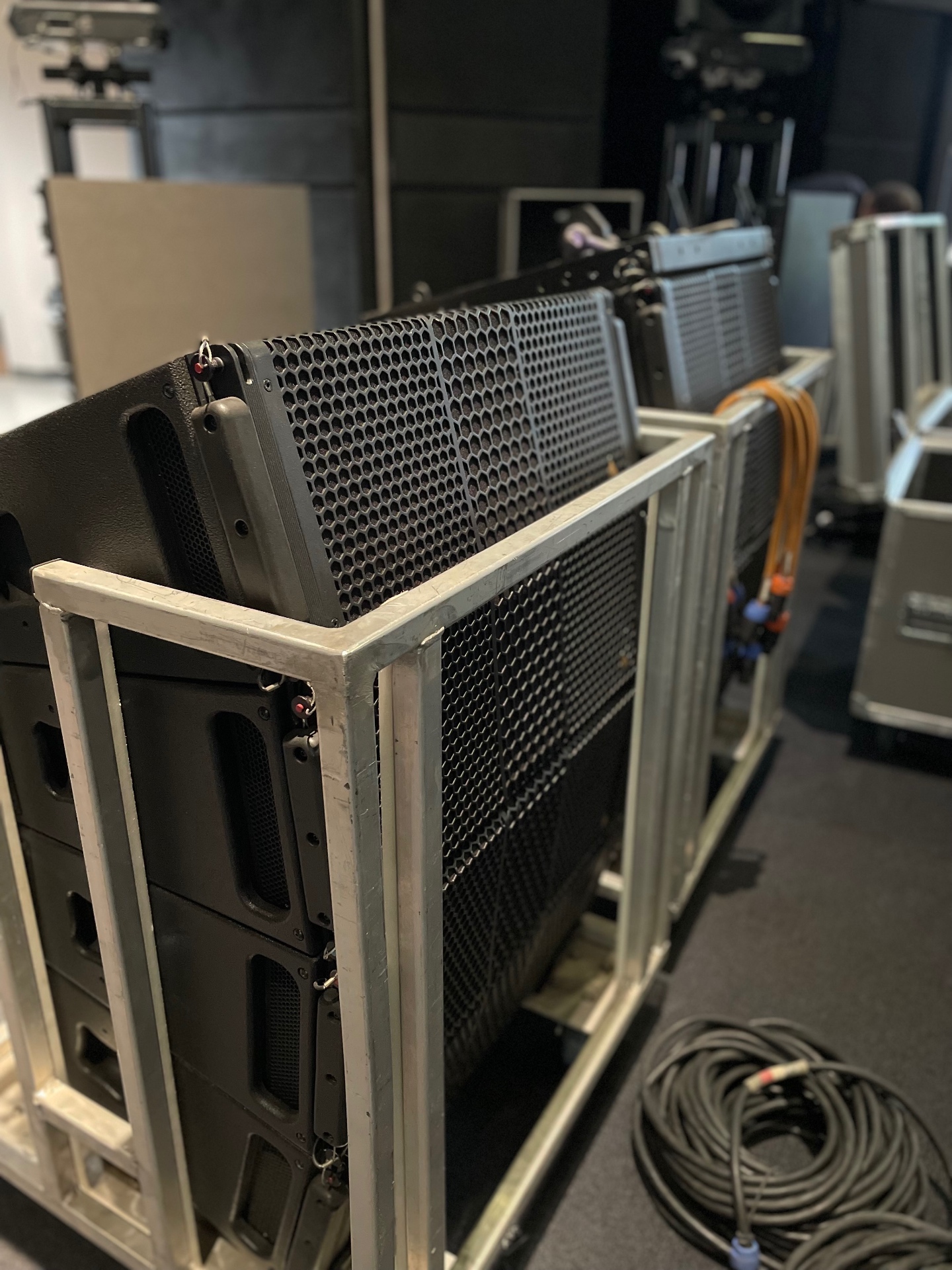 Line array boxes staged on transport carts before deployment